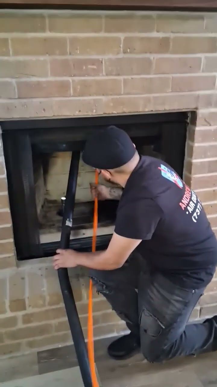 Andrew sweeping a chimney flue in an Austin home