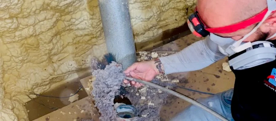 A thick mass of lint pulled out of a dryer vent line during a cleaning