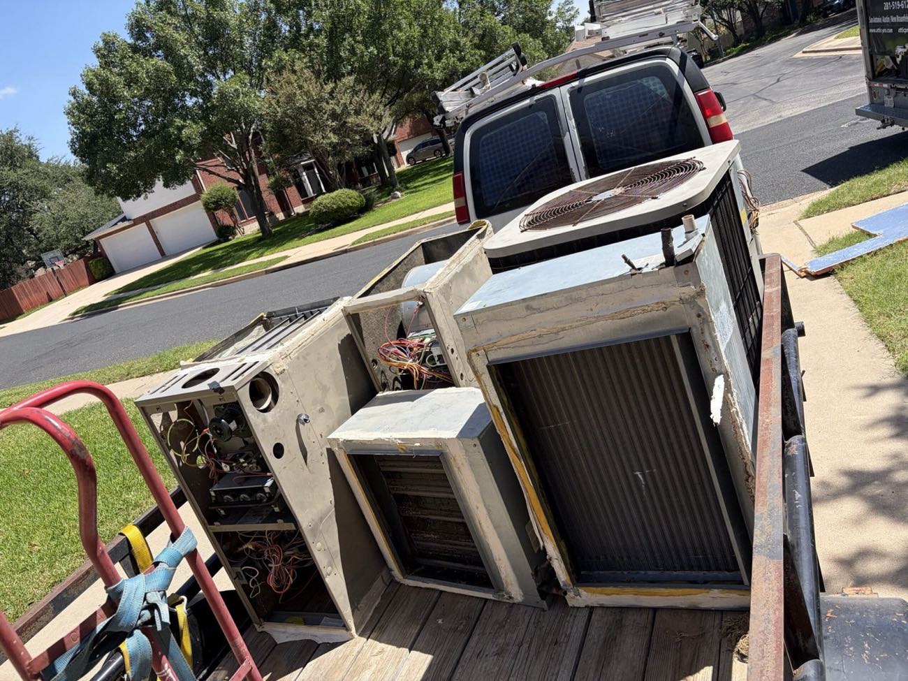 Old HVAC unit removed from an Austin home and loaded onto the trailer