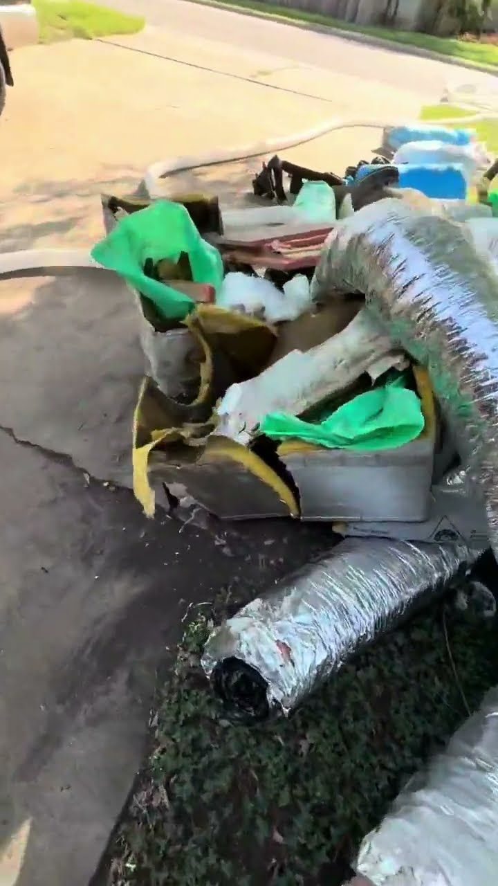 Contaminated attic insulation being removed from an Austin home